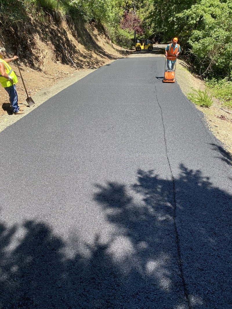 Custom Asphalt Paving - Man pushing Machine